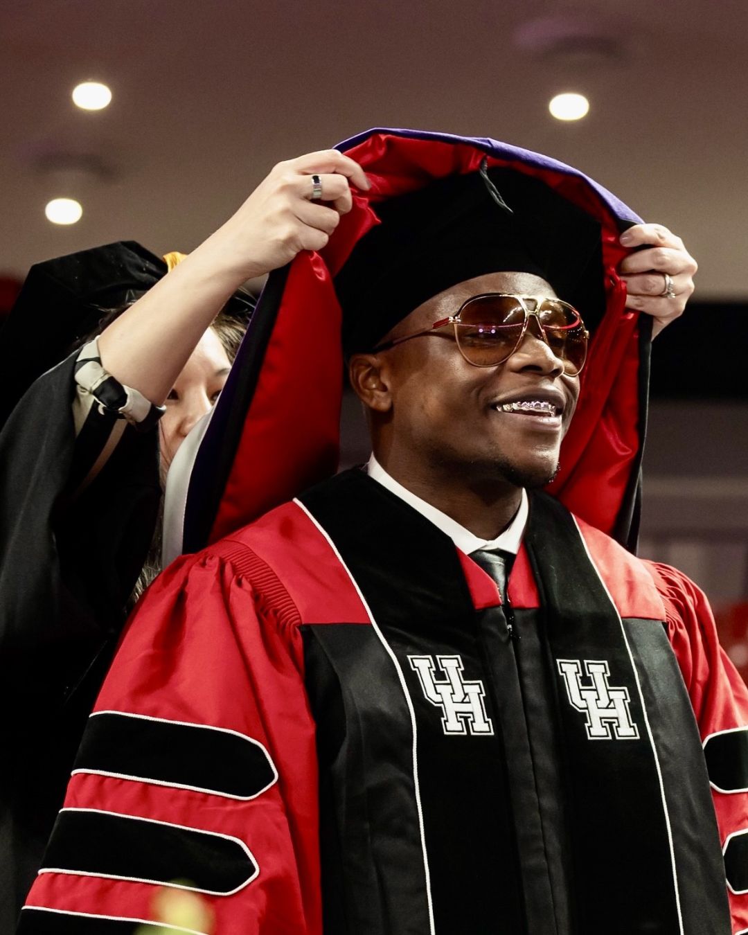 UHLC alum Ugonna Abakwue with caps he designed.