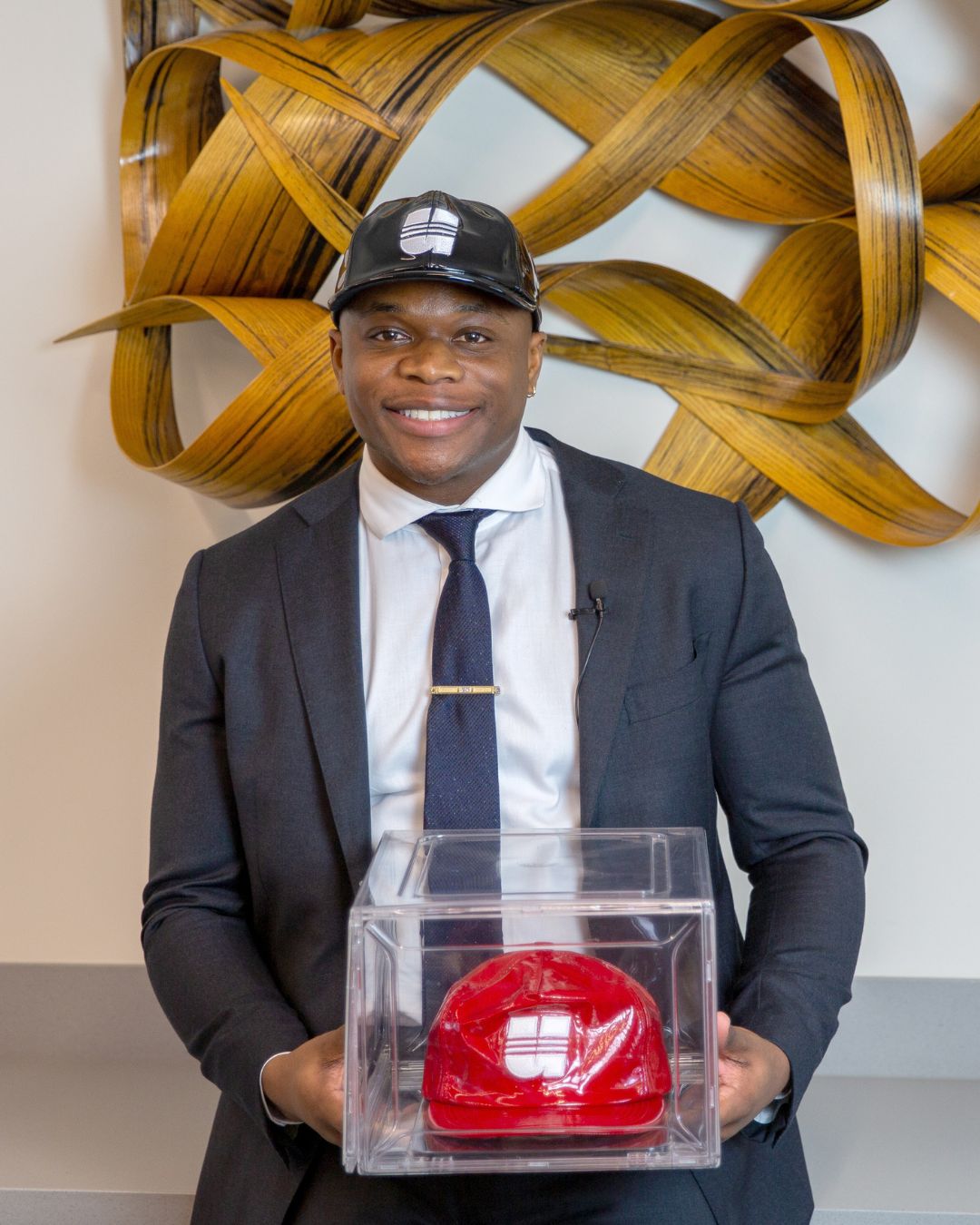 UHLC alum Ugonna Abakwue with caps he designed.