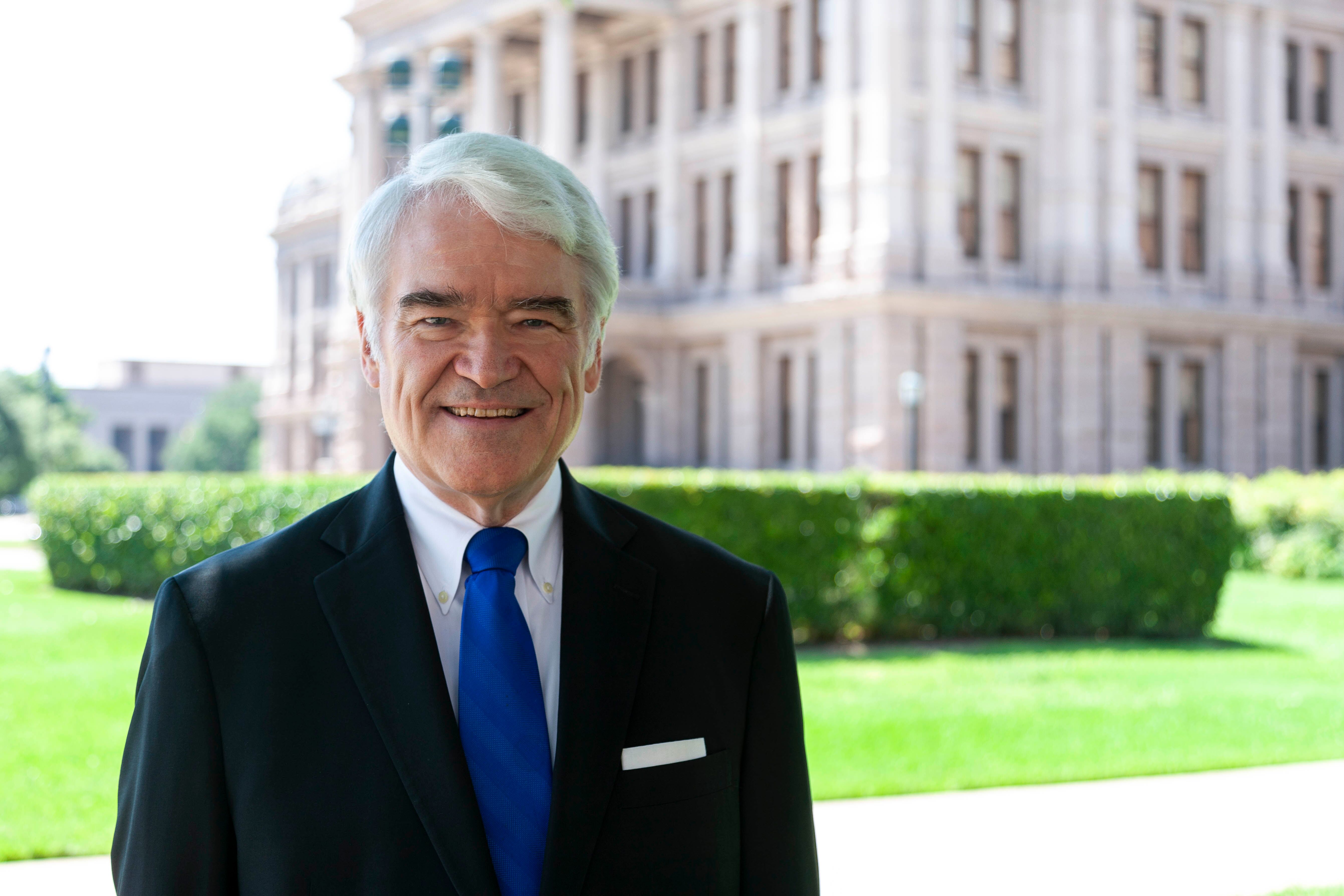 Nathan L. Hecht, former chief justice of the Supreme Court of Texas, standing outdoors in front of a government building.